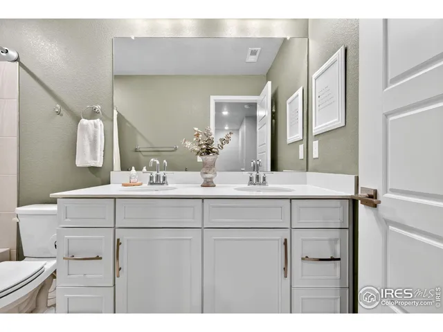 a bathroom with a sink vanity granite and a mirror