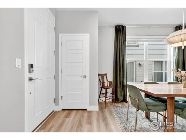 a dining room with furniture and wooden floor