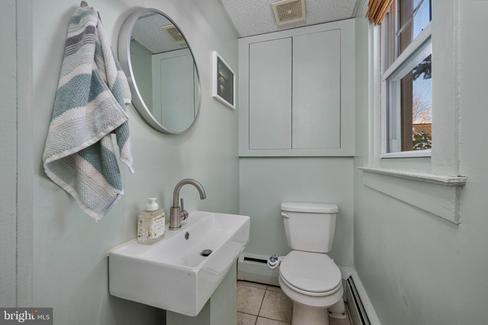 19 East 2nd Avenue Lititz, PA 17543 - Photo 17 of 32 a bathroom with a toilet sink and mirror