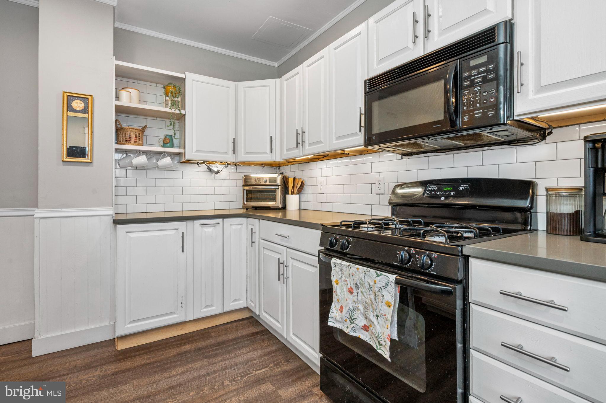 19 East 2nd Avenue Lititz, PA 17543 - Photo 7 of 32 a kitchen with granite countertop cabinets stainless steel appliances and wooden floor