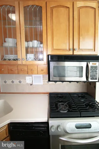 a kitchen with stainless steel appliances a stove and a microwave