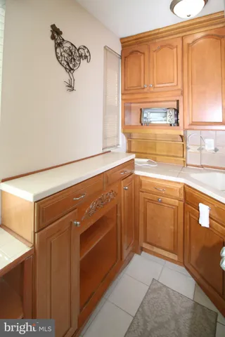 a kitchen with cabinets and a stove top oven