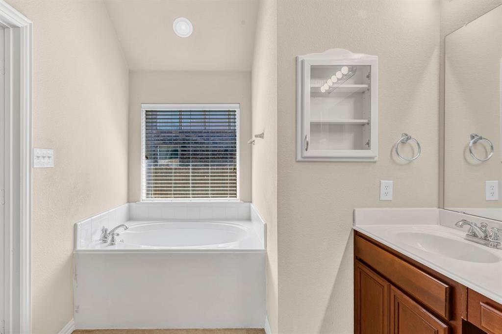 5316 Ridgeson Drive McKinney, TX 75071 - Photo 27 of 33 Built-in bathtub with a white surround and an overhead window with blinds