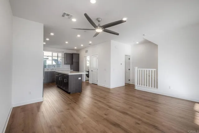 an open kitchen with white cabinets and stainless steel appliances