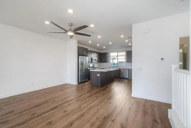 a view of a kitchen with a sink and a refrigerator
