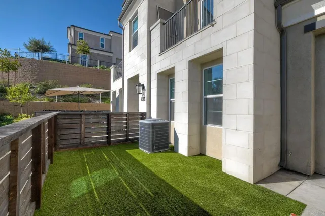 a view of a backyard with wooden fence