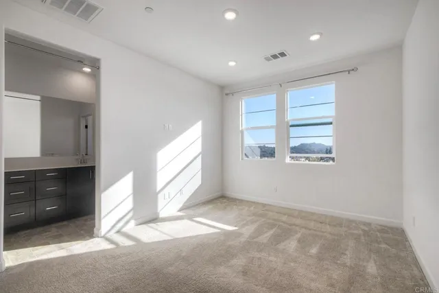 a bathroom with double vanity sinks and a shower
