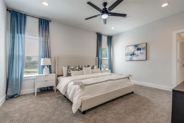 a bedroom with a bed chandelier and a window