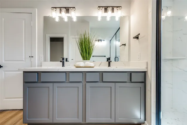 a bathroom with a double vanity sink and a mirror