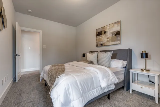 a bedroom with bed and cupboard