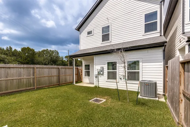 a backyard of a house with barbeque oven