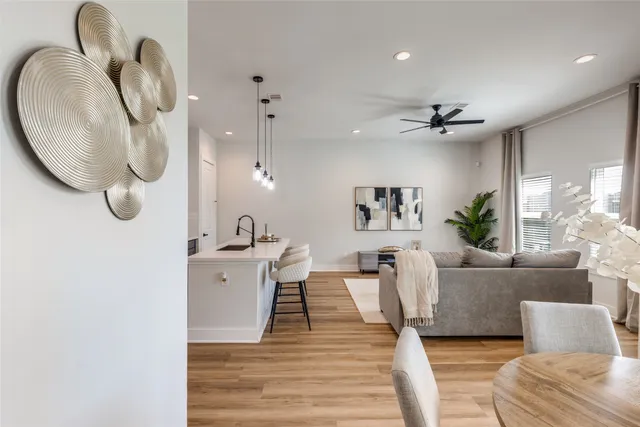 a living room with furniture a mirror and white walls