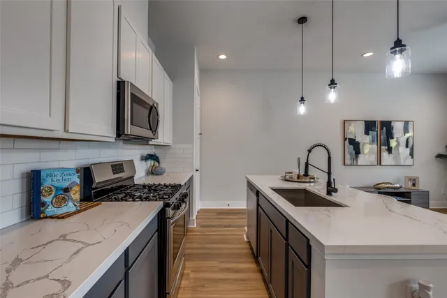 a kitchen that has a sink and a stove