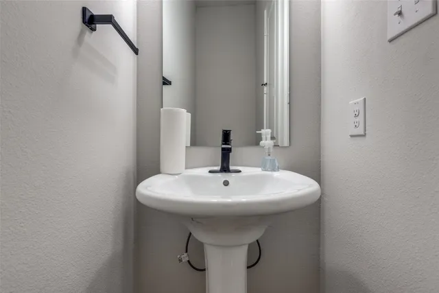 a bathroom with a sink a mirror and shower