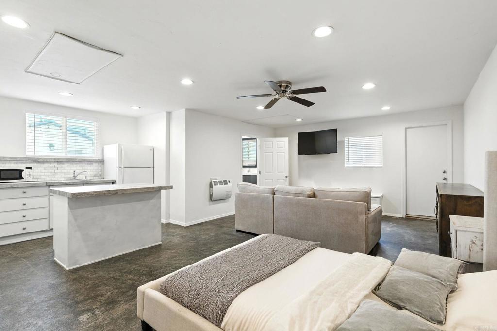 835 Dewitt Avenue, Unit B Encinitas, CA 92024 - Photo 2 of 22 a large white kitchen with a stove a sink a dining table and chairs
