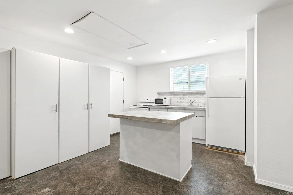 835 Dewitt Avenue, Unit B Encinitas, CA 92024 - Photo 4 of 22 a kitchen with kitchen island sink cabinets and refrigerator