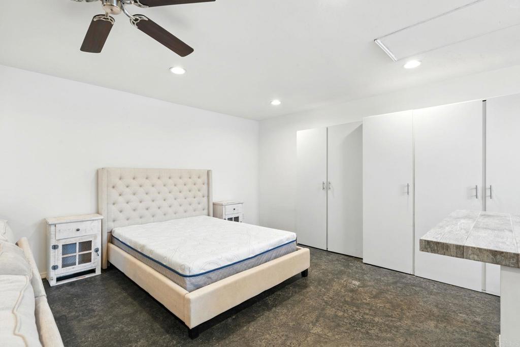 835 Dewitt Avenue, Unit B Encinitas, CA 92024 - Photo 7 of 22 a bedroom with a bed and a chandelier