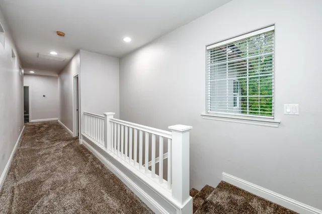 a view of hallway with windows