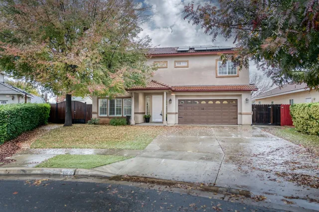 a view of a house with a yard and garage