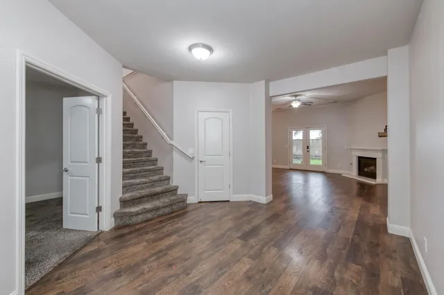 a view of a room with wooden floor and stairs