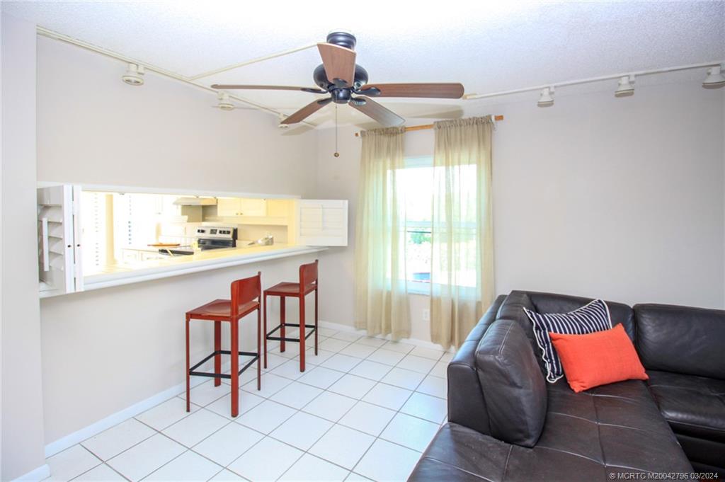 2641 Northeast Ocean Boulevard, Unit 101 Stuart, FL 34996 - Photo 13 of 41 a living room with a couch and a table