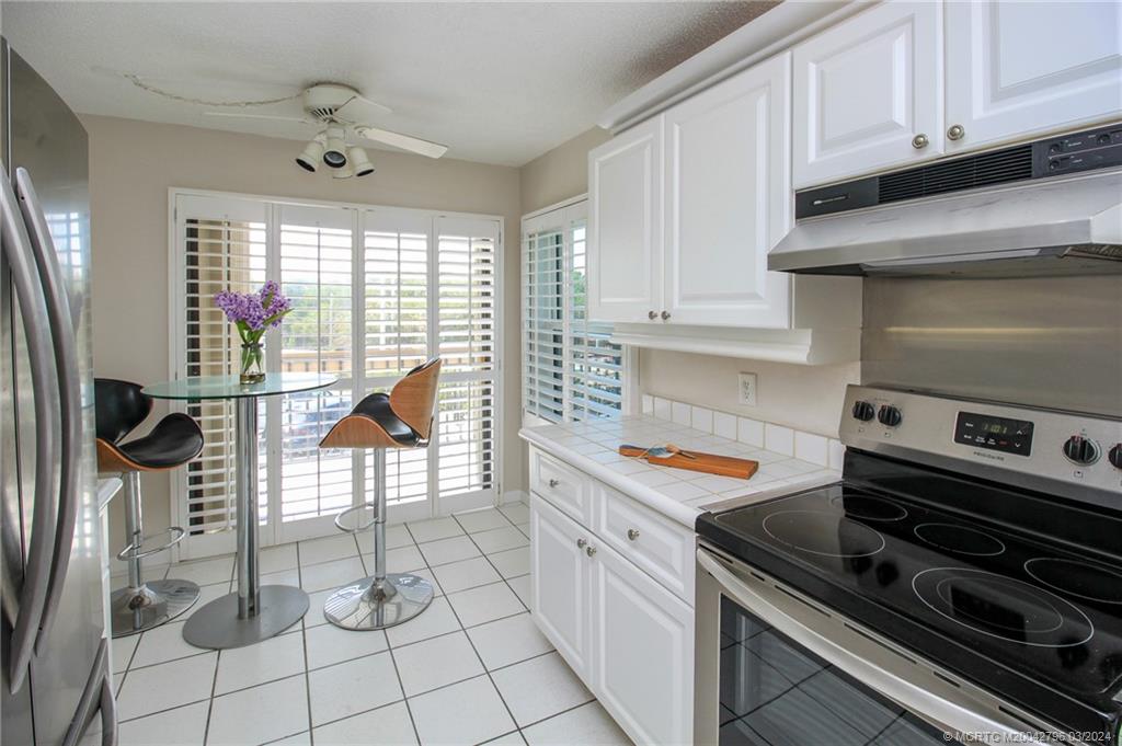 2641 Northeast Ocean Boulevard, Unit 101 Stuart, FL 34996 - Photo 15 of 41 a kitchen with granite countertop a stove and a sink