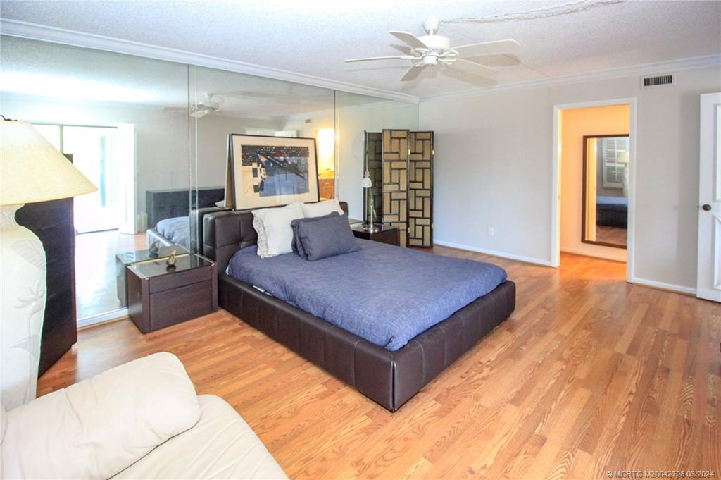 2641 Northeast Ocean Boulevard, Unit 101 Stuart, FL 34996 - Photo 20 of 41 a living room with furniture rug and wooden floor