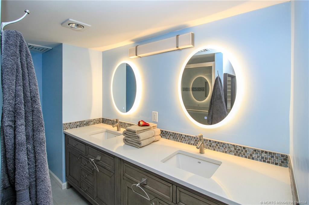2641 Northeast Ocean Boulevard, Unit 101 Stuart, FL 34996 - Photo 21 of 41 a bathroom with a sink and a mirror