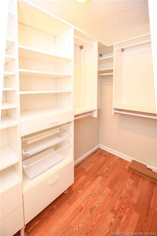 2641 Northeast Ocean Boulevard, Unit 101 Stuart, FL 34996 - Photo 23 of 41 a view of a room with wooden floor and cabinet