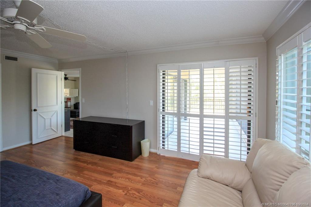 2641 Northeast Ocean Boulevard, Unit 101 Stuart, FL 34996 - Photo 24 of 41 a living room with furniture and a flat screen tv