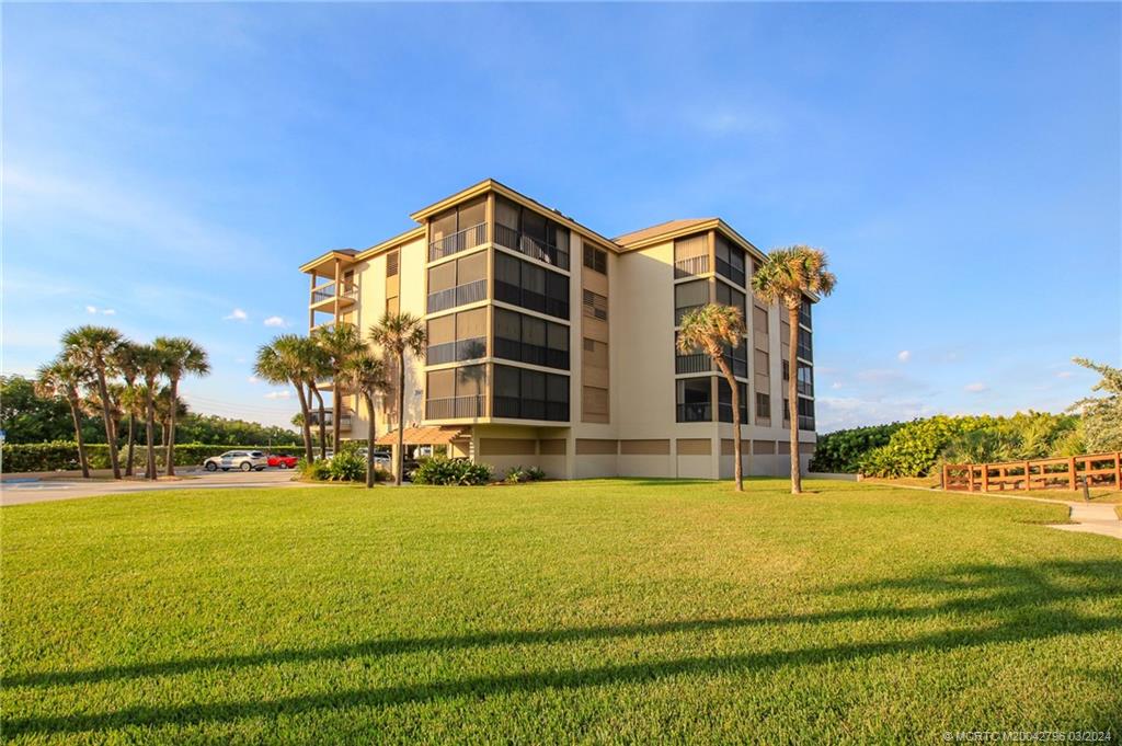 2641 Northeast Ocean Boulevard, Unit 101 Stuart, FL 34996 - Photo 33 of 41 a view of building with yard