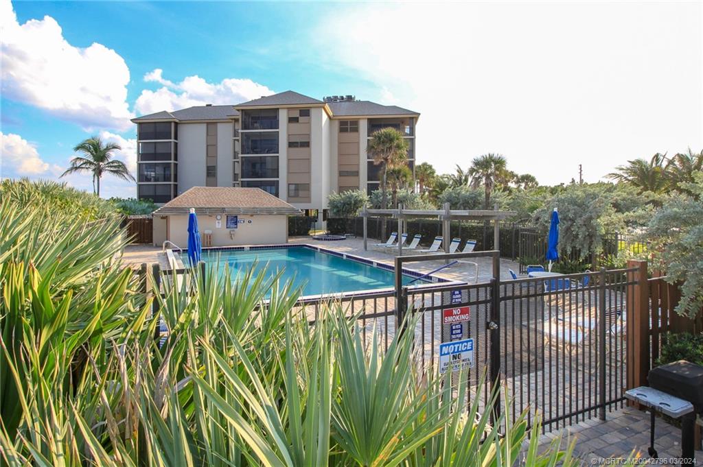 2641 Northeast Ocean Boulevard, Unit 101 Stuart, FL 34996 - Photo 34 of 41 a view of a house with a swimming pool