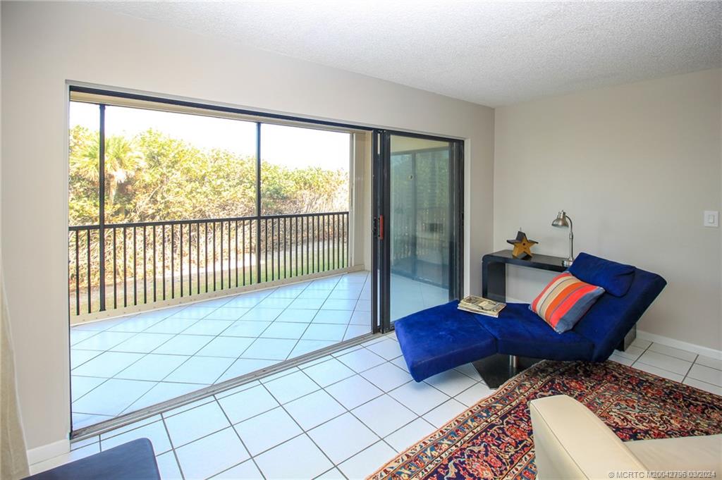 2641 Northeast Ocean Boulevard, Unit 101 Stuart, FL 34996 - Photo 8 of 41 a view of a bedroom with furniture and wooden floor