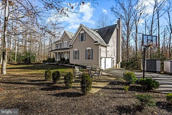 a view of a house with a yard covered with snow