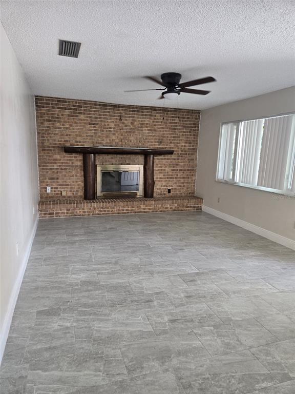 1420 Simmons Road Kissimmee, FL 34744 - Photo 4 of 21 a view of empty room with window and fireplace