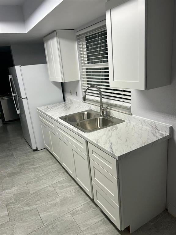 1420 Simmons Road Kissimmee, FL 34744 - Photo 7 of 21 a kitchen with a sink and cabinets