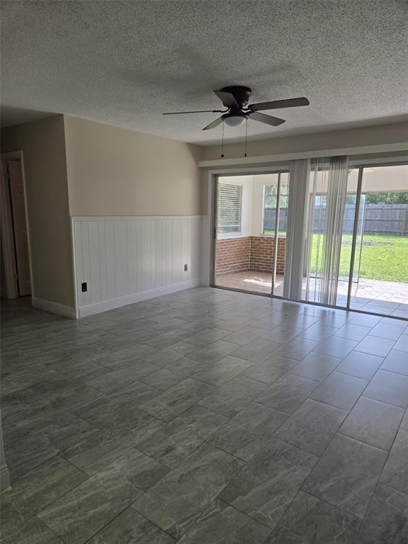 1420 Simmons Road Kissimmee, FL 34744 - Photo 8 of 21 a view of empty room with wooden floor and fan