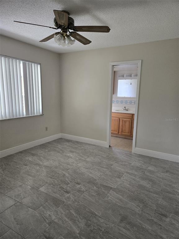 1420 Simmons Road Kissimmee, FL 34744 - Photo 9 of 21 a view of a livingroom with a ceiling fan and window