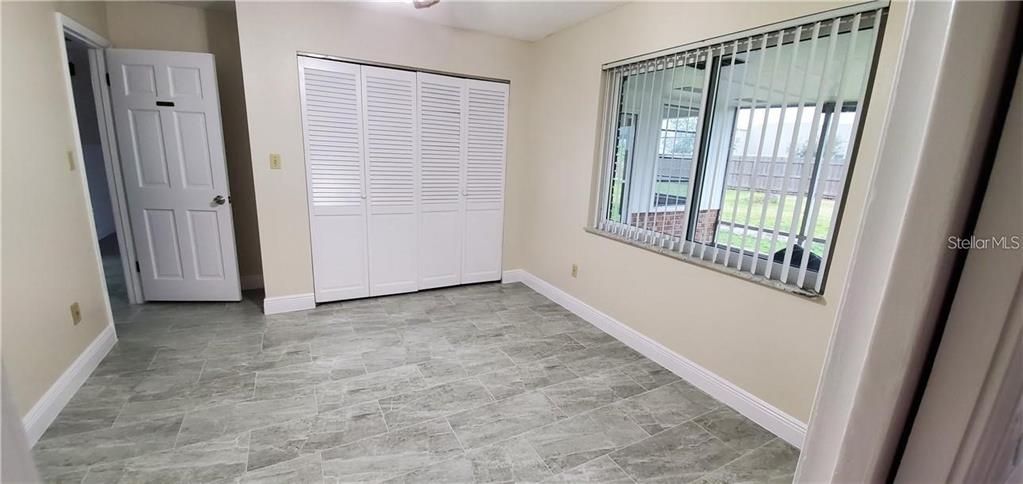 1420 Simmons Road Kissimmee, FL 34744 - Photo 10 of 21 an empty room with windows