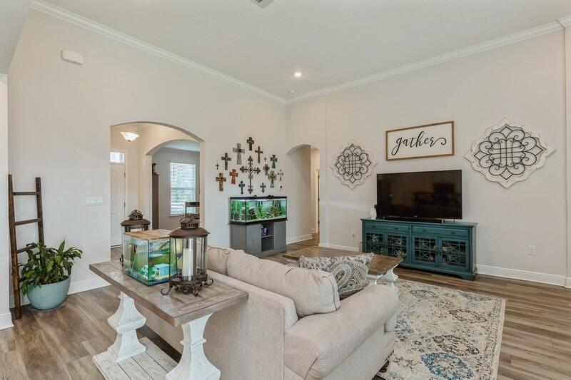 221 Sweet Tea Lane Freeport, FL 32439 - Photo 11 of 55 a living room with furniture and a flat screen tv