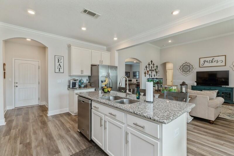 221 Sweet Tea Lane Freeport, FL 32439 - Photo 13 of 55 a kitchen with kitchen island granite countertop a sink and microwave