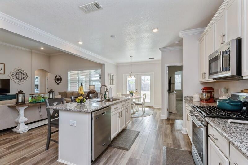 221 Sweet Tea Lane Freeport, FL 32439 - Photo 14 of 55 a kitchen with a sink stove and cabinets