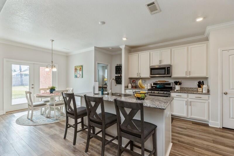 221 Sweet Tea Lane Freeport, FL 32439 - Photo 15 of 55 a view of a dining room with furniture wooden floor and a view of kitchen