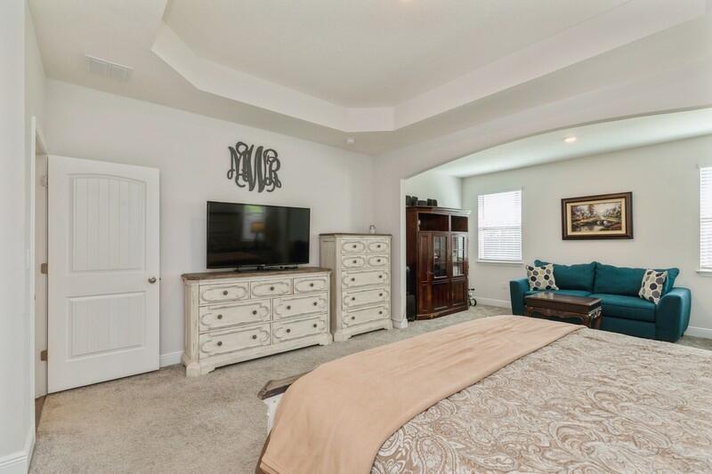 221 Sweet Tea Lane Freeport, FL 32439 - Photo 19 of 55 a bedroom with a bed and a flat screen tv