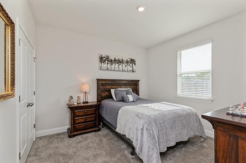 221 Sweet Tea Lane Freeport, FL 32439 - Photo 22 of 55 a bedroom with a bed and a table in it