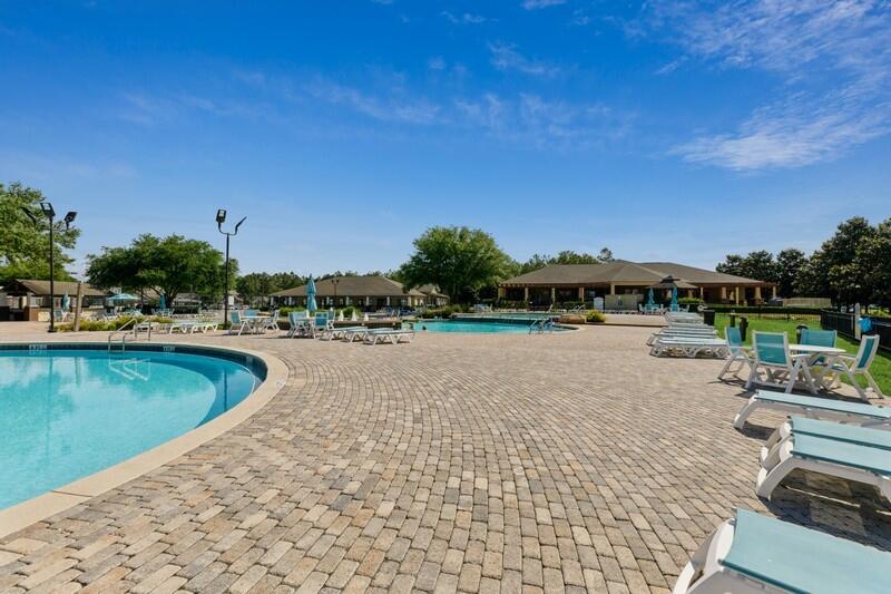 221 Sweet Tea Lane Freeport, FL 32439 - Photo 39 of 55 a view of a swimming pool and lounge chairs