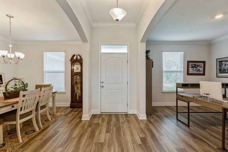 221 Sweet Tea Lane Freeport, FL 32439 - Photo 4 of 55 a view of a livingroom with furniture and wooden floor