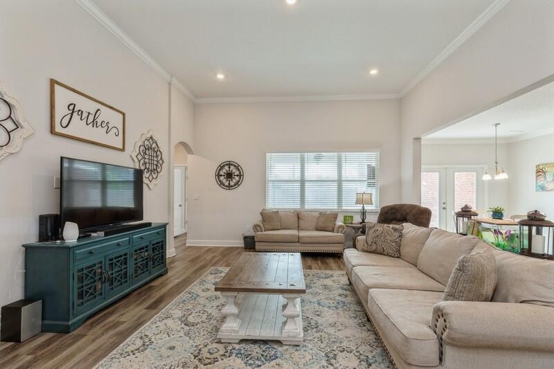 221 Sweet Tea Lane Freeport, FL 32439 - Photo 7 of 55 a living room with furniture and a flat screen tv