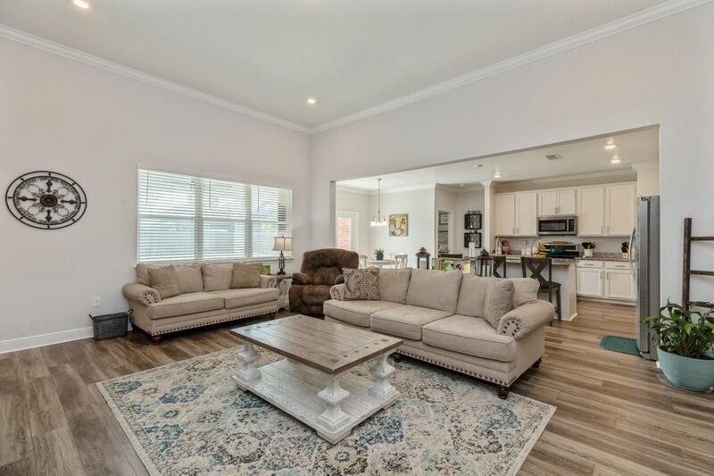 221 Sweet Tea Lane Freeport, FL 32439 - Photo 8 of 55 a living room with furniture and a large window