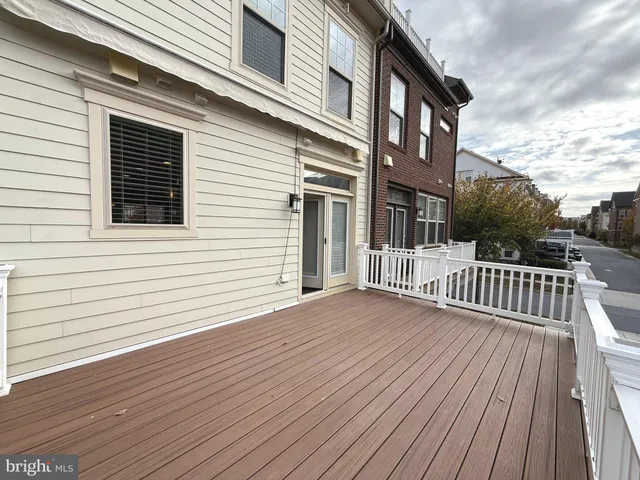 a view of a house with wooden deck